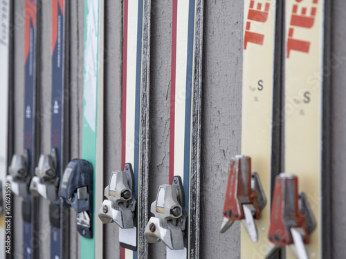 Old Alpine Skis With Bindings Mounted and displayed On A Wall