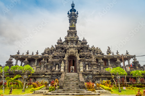 BALI, INDONESIA - MARCH 08, 2017: Panoramic landscape traditional balinese hindu temple Bajra Sandhi monument in Denpasar, Bali, Indonesia on background tropical nature and blue summer sky, Indonesia photo