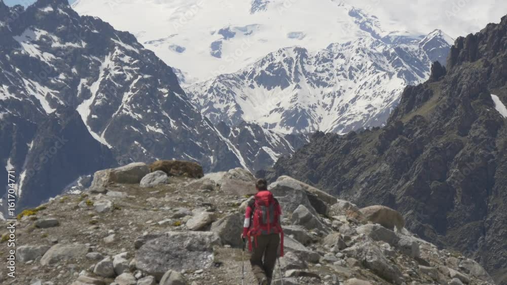 Young woman walking on top of the mountain Young woman walking on top of the mountain