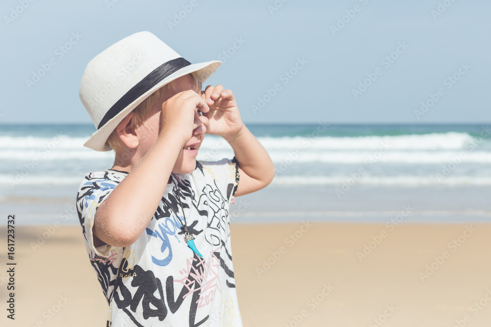 Caucasian boy from europe with happy and relax time on the tropical beach at Karon, Phuket, Thailand Caucasian boy from europe with happy and relax time on the tropical beach at Karon, Phuket, Thailand