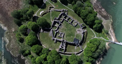 Medieval castle ruins, Cinema 4k aerial tilt away view of kuusiston linnan rauniot, on a sunny summer day, in Kaarina, Turku, Finland photo