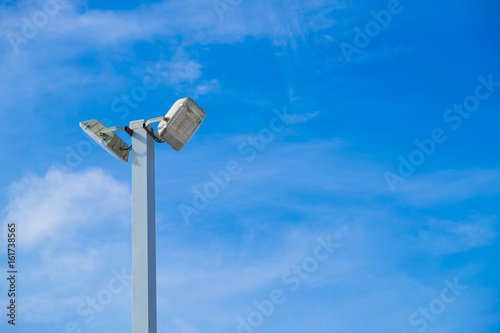 Lamp post electricity industry with blue sky background. Spotlight tower.