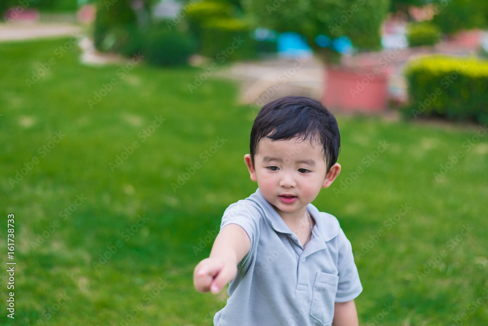 Little Asian kid at the playground under the sunlight, shallow DOF Little Asian kid at the playground under the sunlight, shallow DOF