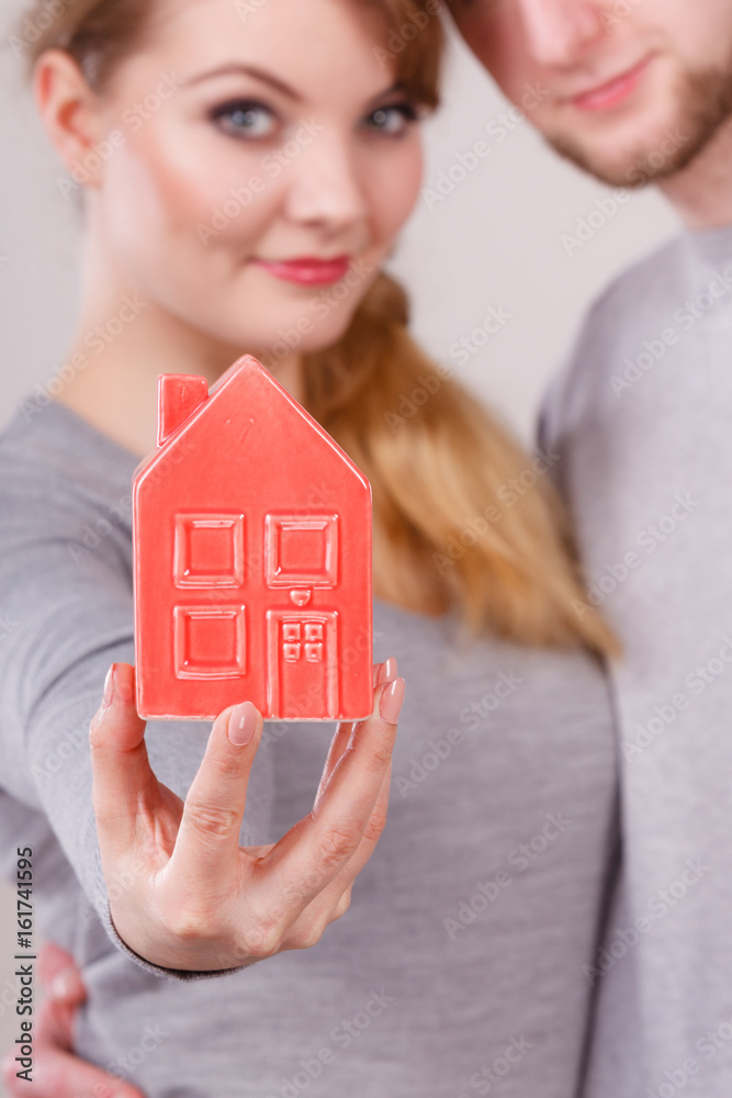 Young enamoured pair showing house symbol. Young enamoured pair showing house symbol.