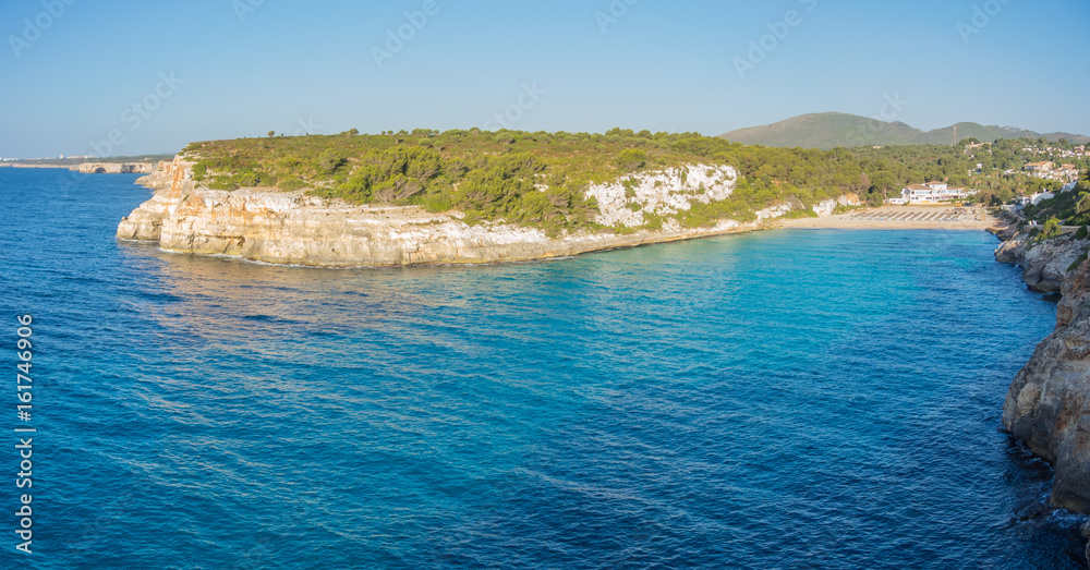 Landscape of the beautiful bay of Cala Estany d'en Mas with a wonderful turquoise sea, Cala romantica, Porto Cristo, Majorca, Spain Landscape of the beautiful bay of Cala Estany d'en Mas with a wonderful turquoise sea, Cala romantica, Porto Cristo, Majorca, Spain