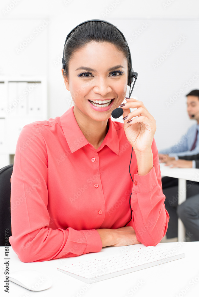 Asian businesswoman wearing microphone headset in the office Asian businesswoman wearing microphone headset in the office