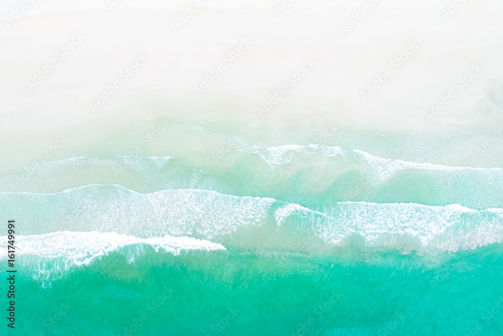 Top view of waves on white sand beach