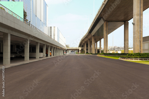 Empty road surface floor with city bridge