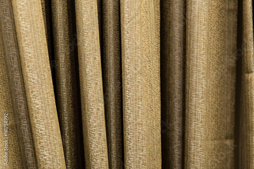 Curtain. Shooting at close range. The texture of the fabric is visible. Color gold.