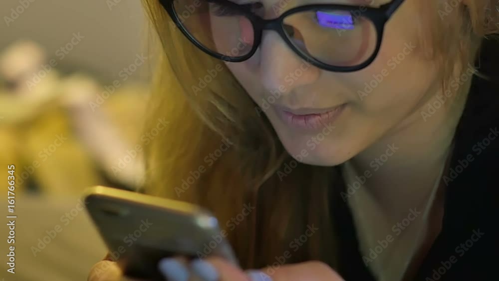 Young woman in glasses using mobile phone Young woman in glasses using mobile phone