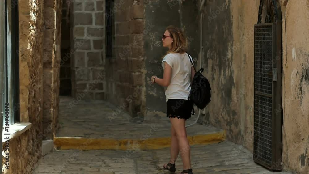 Female tourist walking exploring old streets Female tourist walking exploring old streets