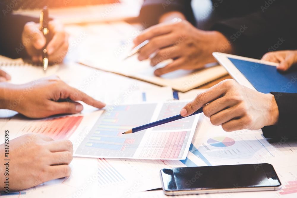 Business partners discussing graph of financial, business concept. Business Concept. select focus Business partners discussing graph of financial, business concept. Business Concept. select focus