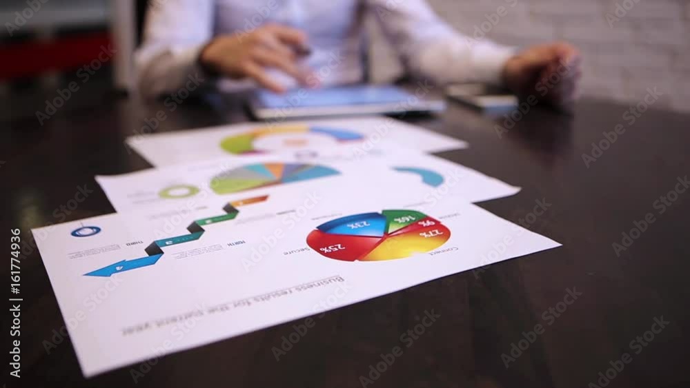 Businessman working in the office with the charts Businessman working in the office with the charts