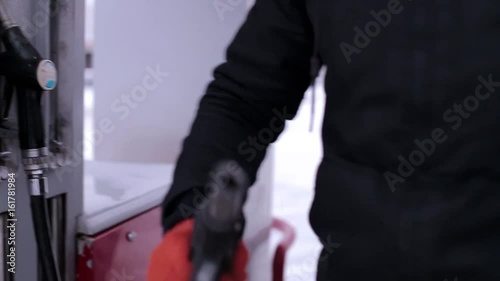 Man pours gasoline into the car