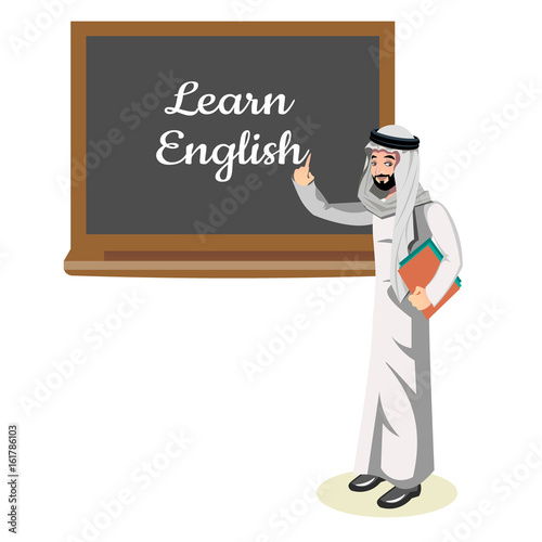 Muslim teacher standing in front of blackboard teaching student in classroom at school.