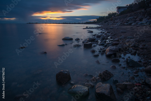 View of the house at the coast after sunset on the Gulf of Finland © puleglot
