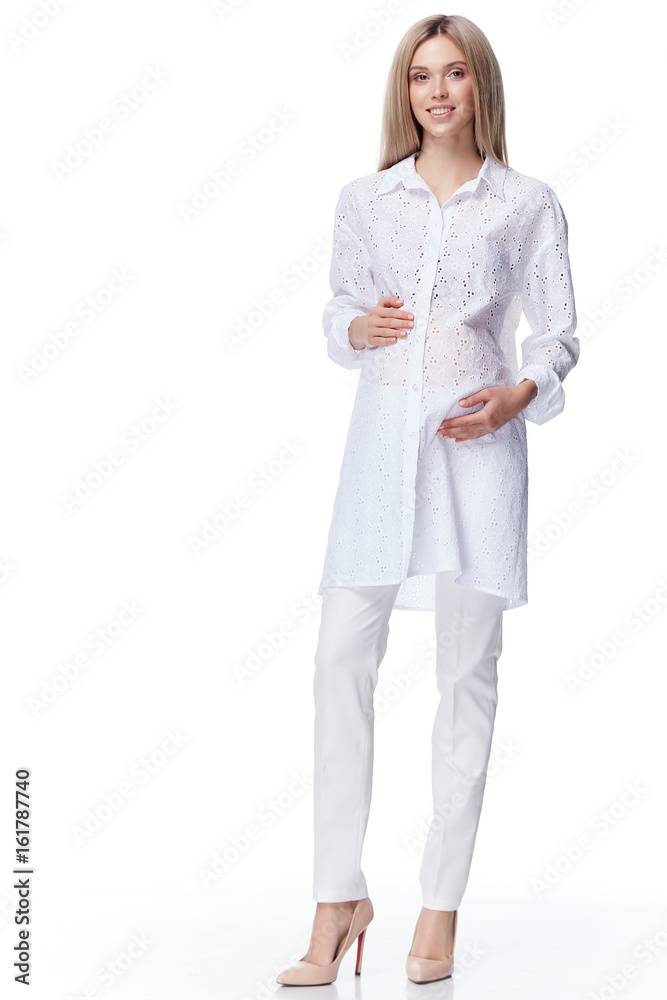 Beautiful elegant pregnant woman blond hair wear style fashion blouse pants mother hold in hand tummy wait for baby child new born pretty lady clothes for pregnancy white background collection heath. Beautiful elegant pregnant woman blond hair wear style fashion blouse pants mother hold in hand tummy wait for baby child new born pretty lady clothes for pregnancy white background collection heath.
