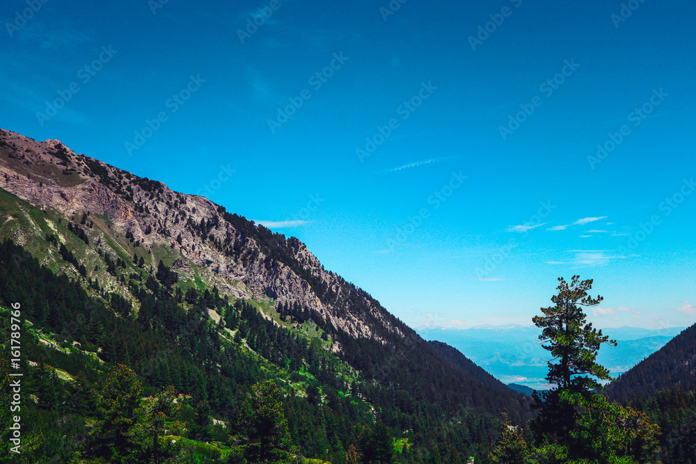 Beautiful view on the high green mountains peaks, on the blue sky background. Mountain hiking paradise landscape, no people. Beautiful view on the high green mountains peaks, on the blue sky background. Mountain hiking paradise landscape, no people.