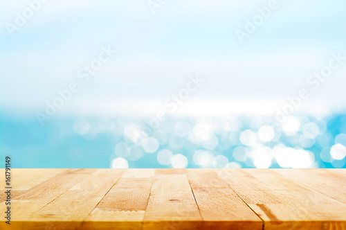 Wood table top on blur summer blue sea and sky background