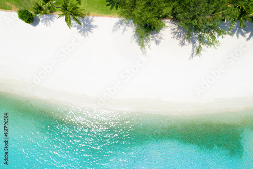 Aerial drone shot of white sand beach with turquoise sea water