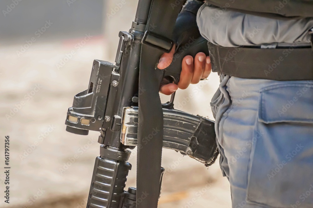 JERUSALEM, ISRAEL. June 20, 2017. Armed with an M-16 Israel border police officer on guard at the terror attack site by the Damascus gate of the Old city of Jerusalem. Security measures stock image. JERUSALEM, ISRAEL. June 20, 2017. Armed with an M-16 Israel border police officer on guard at the terror attack site by the Damascus gate of the Old city of Jerusalem. Security measures stock image.