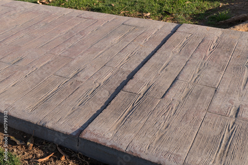 stamped concrete pavement outdoor with expansion joint working, Wooden slats pattern, flooring exterior, decorative texture of cement paving with streaks of wood
