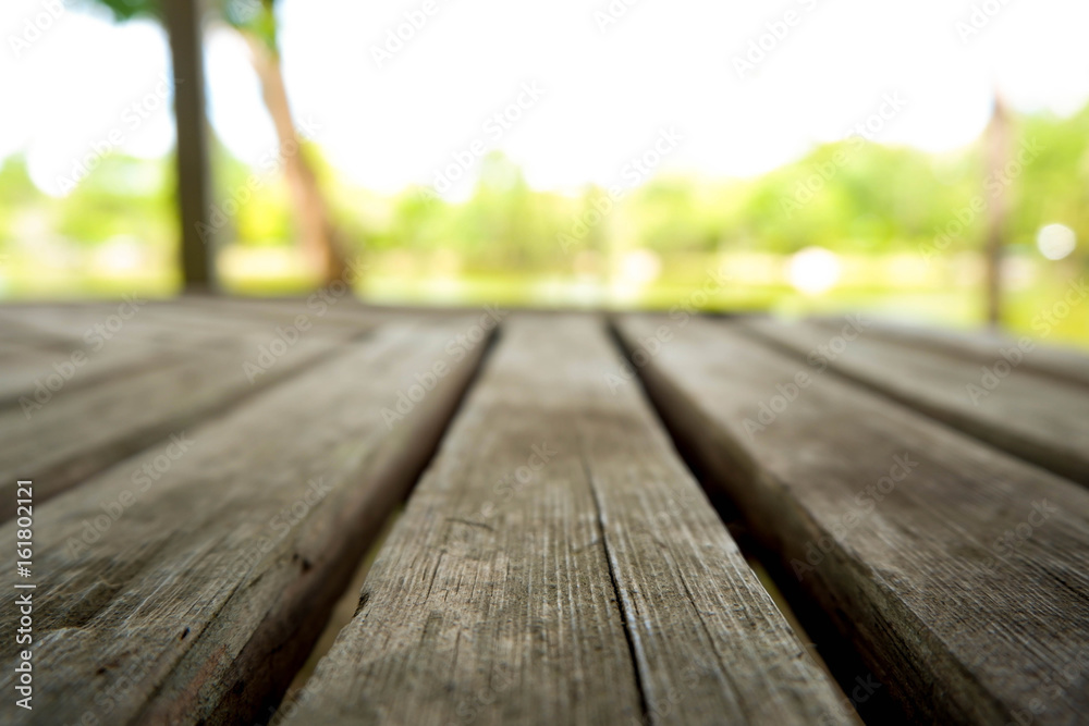 Wooden floor with a blurred background sky tre and a lake. Wooden floor with a blurred background sky tre and a lake.