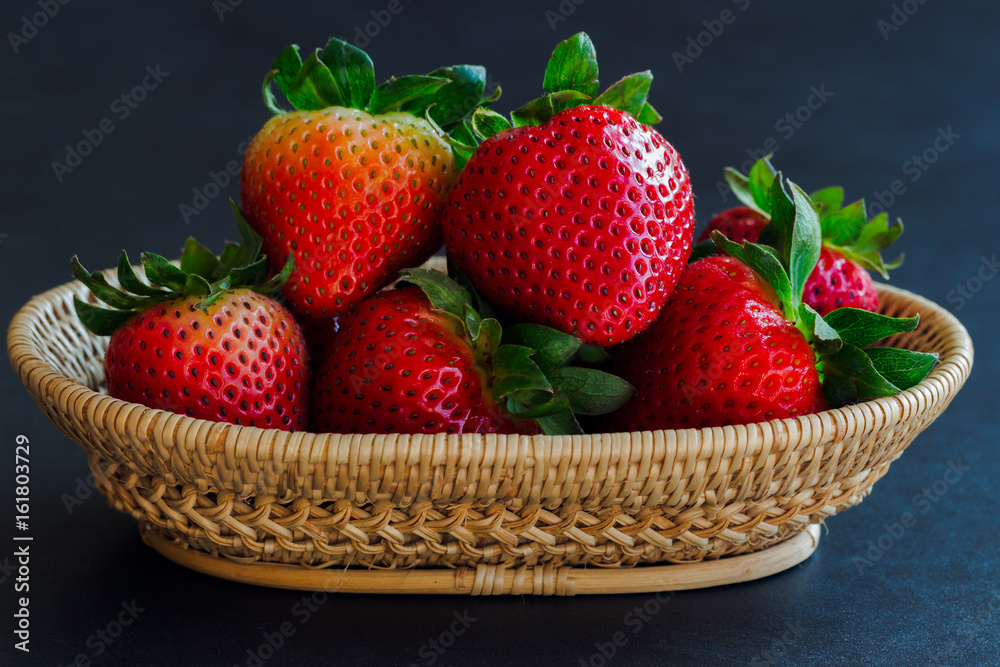 Fresh strawberries on granite background. Ripe strawberry in basket on granite table. Copy space background of strawberry for your design. Extremely exposure fruit  concept background or wallpaper.