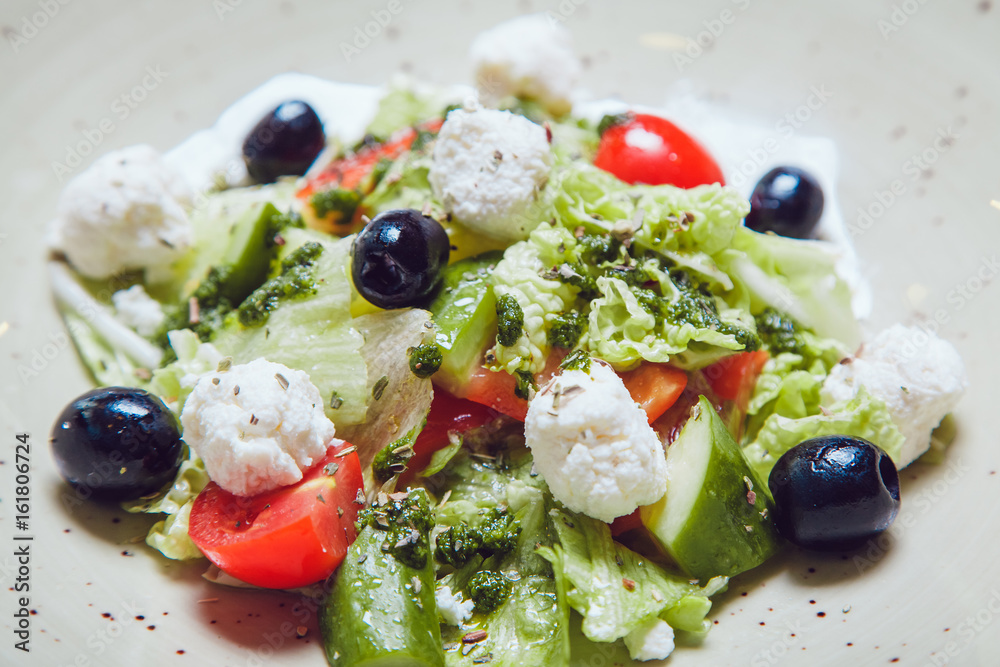 Greek salad with fresh vegetables, feta cheese and black olives Greek salad with fresh vegetables, feta cheese and black olives