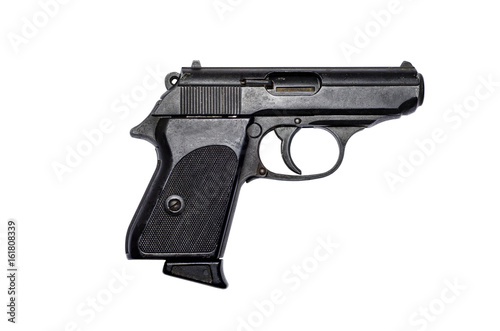Used black metal pistol gun on white background photo