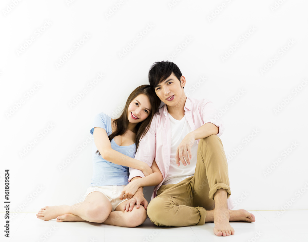 Portrait Of Happy Young Couple Sitting On Floor. Portrait Of Happy Young Couple Sitting On Floor.