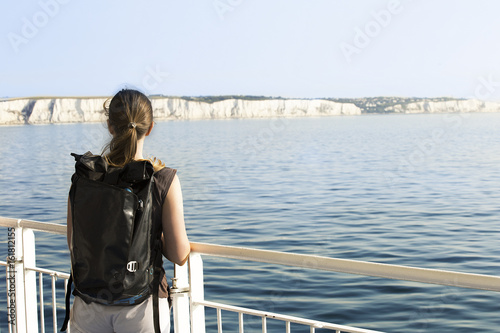 Woman backpacker crossing English channel by ferry from Dover to Calais © melecis