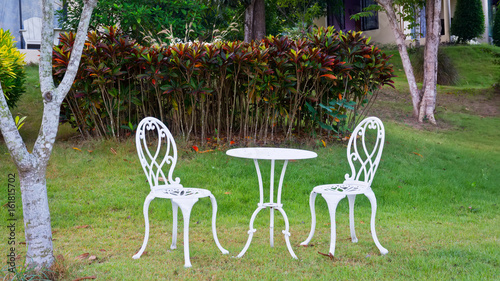 white table and chairs  in a garden