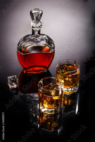 Decanter and two glasses with whisky and ice