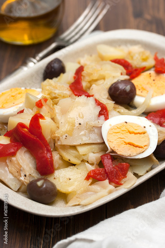 cod fish with boiled vegetables and egg on the dish