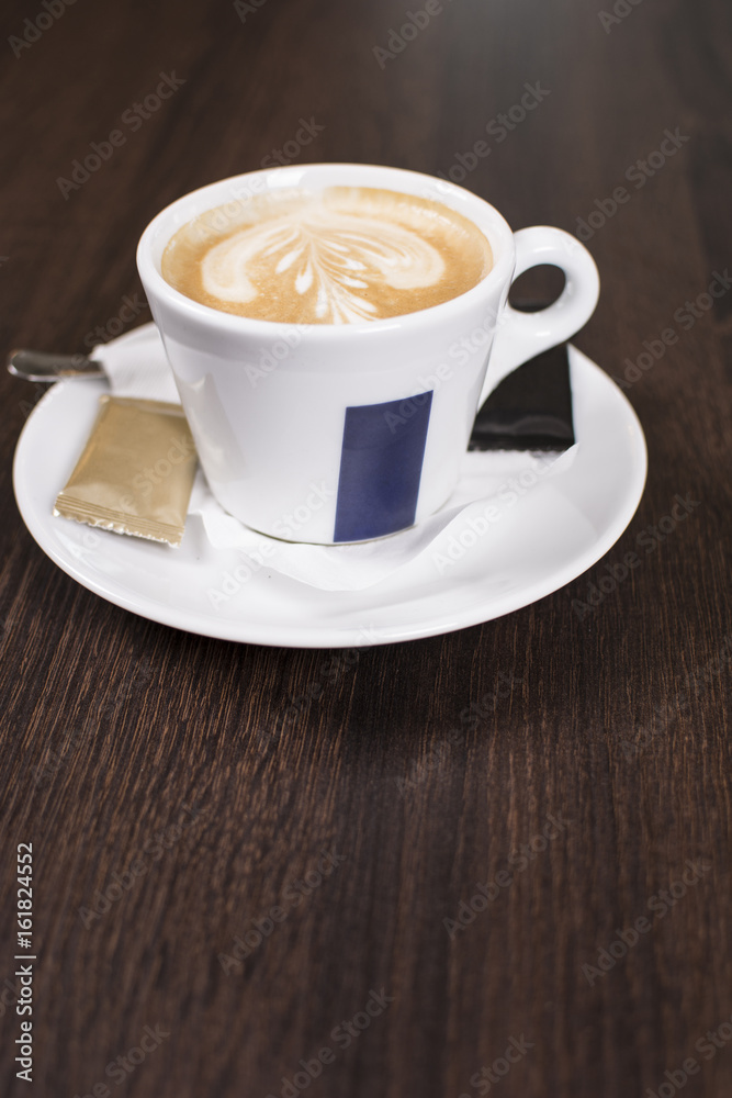 Cup of coffee with beautiful latte art. Tasty cup of coffee on wooden background with beautiful latte art. Cup of coffee with beautiful latte art. Tasty cup of coffee on wooden background with beautiful latte art.
