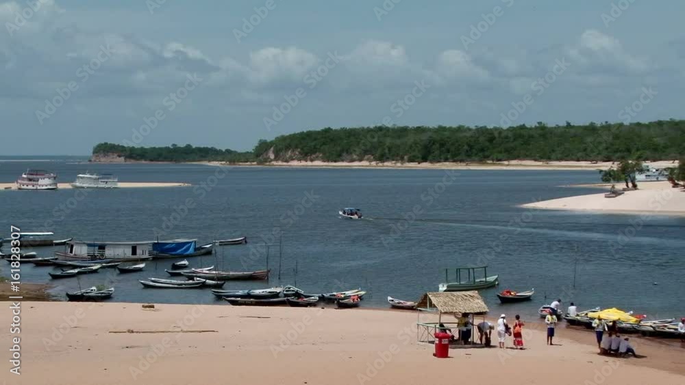 Static shot of sandy beaches at Alter do Chao, Para state, Brazil. A lots small wooden boats tied up on the forehead Static shot of sandy beaches at Alter do Chao, Para state, Brazil. A lots small wooden boats tied up on the forehead