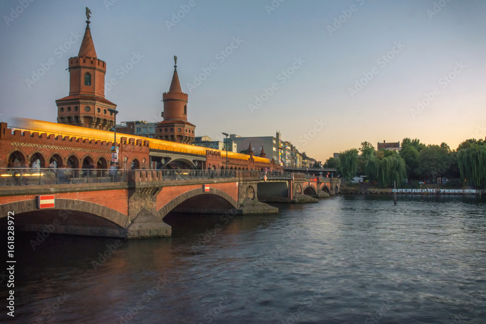 river bridge with yellow train in the sunset