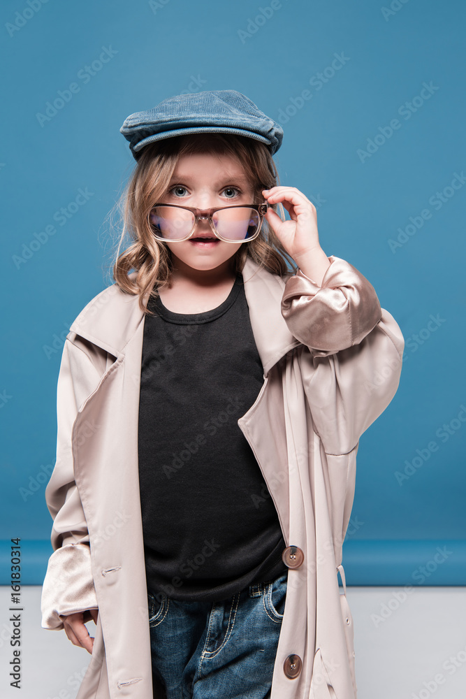 portrait of pretty child girl in glasses and oversized coat portrait of pretty child girl in glasses and oversized coat