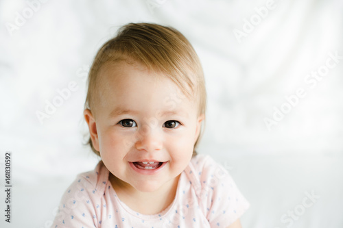 Beatiful baby girl smiling in bed
