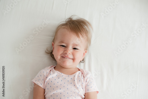 Beatiful baby smiling in bed