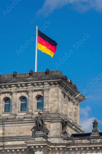 detail of the german flag on the top of an ancient building in berlin