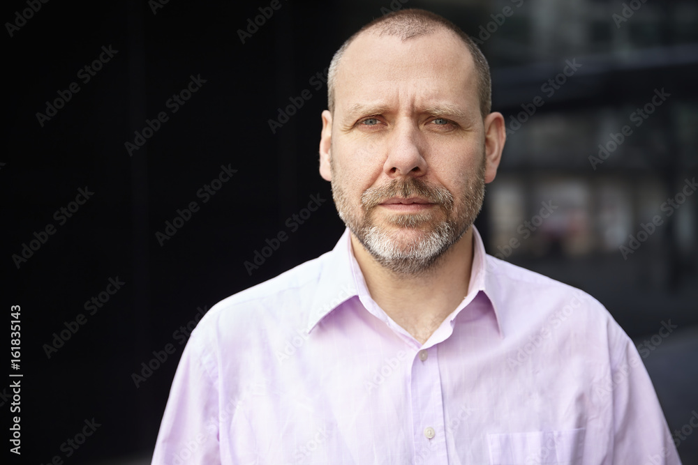 Mature office worker in front of his office Mature office worker in front of his office