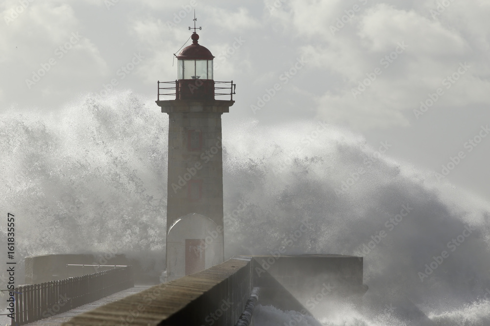 Big wave against lighthouse