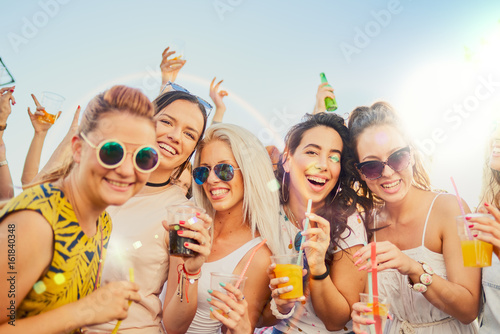 Friends at festival, drinking, chatting and having a good time