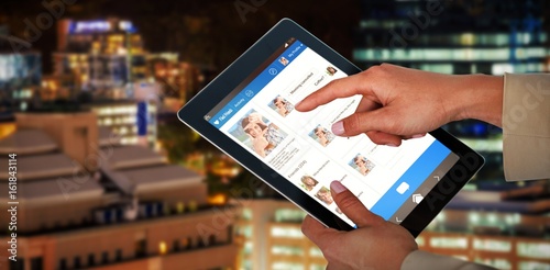 Composite 3d image of businesswoman using digital tablet