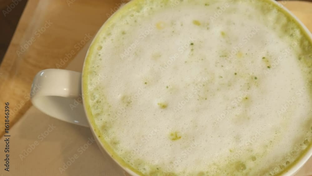Panning shot of Matcha Green Tea Latte on Wooden dish Panning shot of Matcha Green Tea Latte on Wooden dish