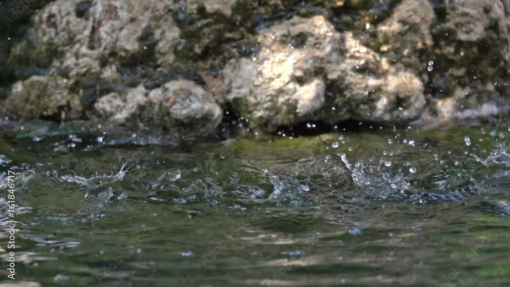 splash close-up falling water drops hits and explodes slow motion splash close-up falling water drops hits and explodes slow motion