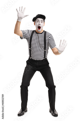 Fényképezés Mime holding his hands on an invisible wall