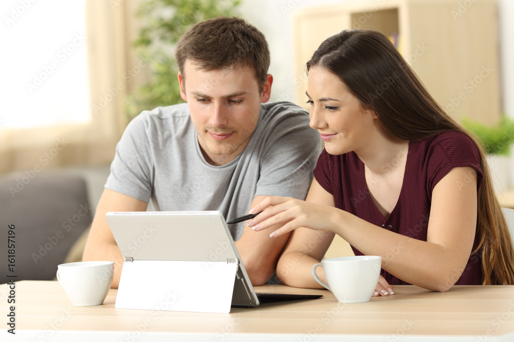 Couple searching on line with a tablet pc Couple searching on line with a tablet pc